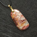 Natural agate pendant detail showing unique earth-formed colors