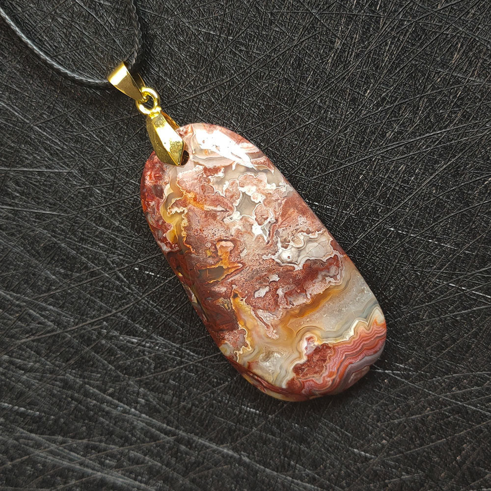 Natural agate pendant detail showing unique earth-formed colors