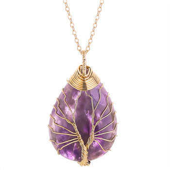 Amethyst pendant necklace with gold wire wrapping on a white background