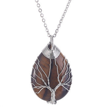 Necklace with a brown teardrop-shaped pendant featuring a tree design on a white background