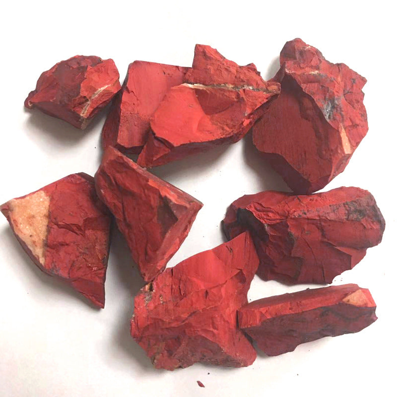 Red stone pieces on a white background