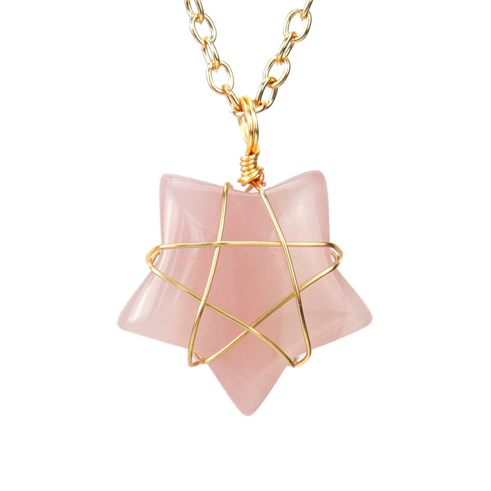 Necklace with a pink stone pendant and gold wire wrapping on a white background