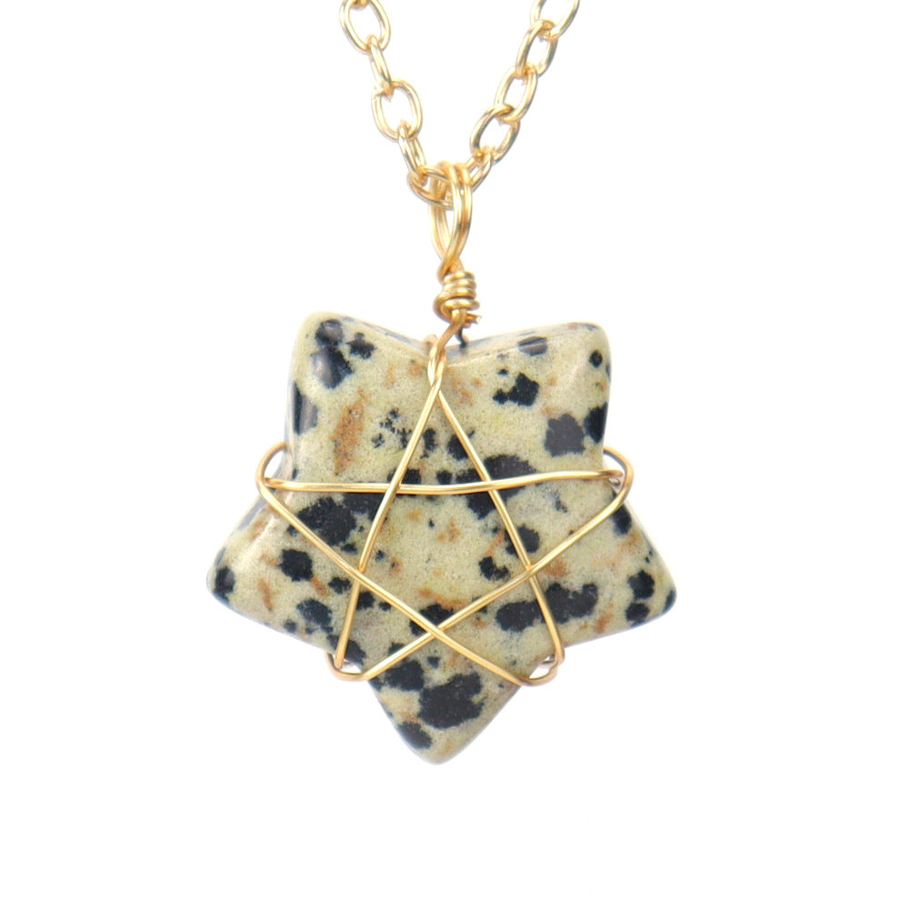 Star-shaped stone pendant with gold wire wrapping on a white background