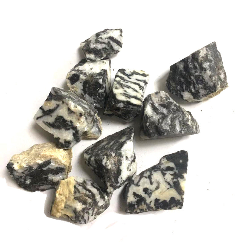 Collection of black and white marbled stones on a white background
