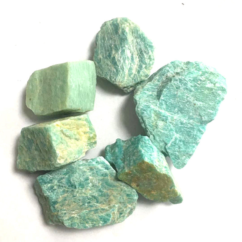 Green and blue striped stones on a white background