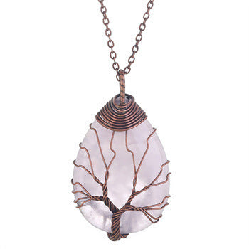 Necklace with a unique pendant featuring a tree design on a white background