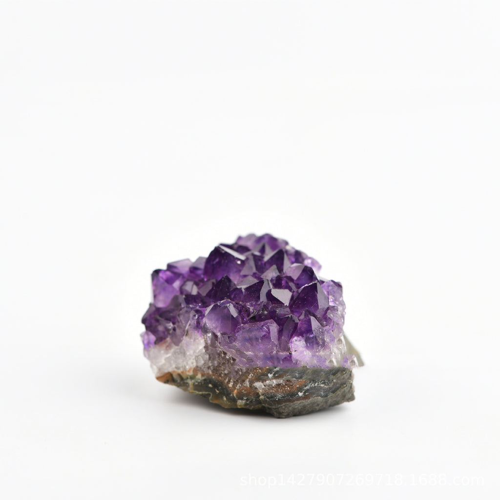 Amethyst crystal cluster on a white background