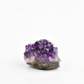 Amethyst crystal cluster on a white background
