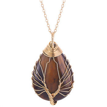 Teardrop-shaped pendant with gold wire wrapping on a white background