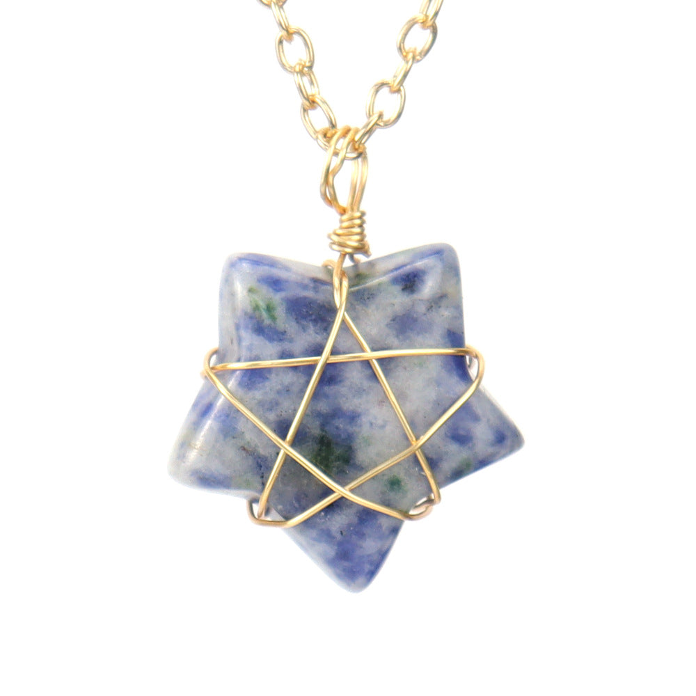 Star-shaped stone pendant with gold wire wrapping on a white background