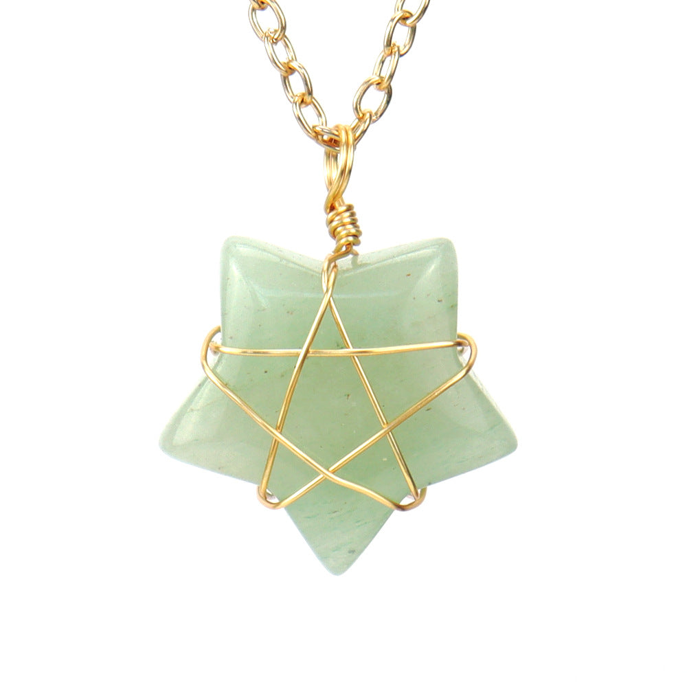Necklace with a green stone pendant and gold wire wrapping on a white background